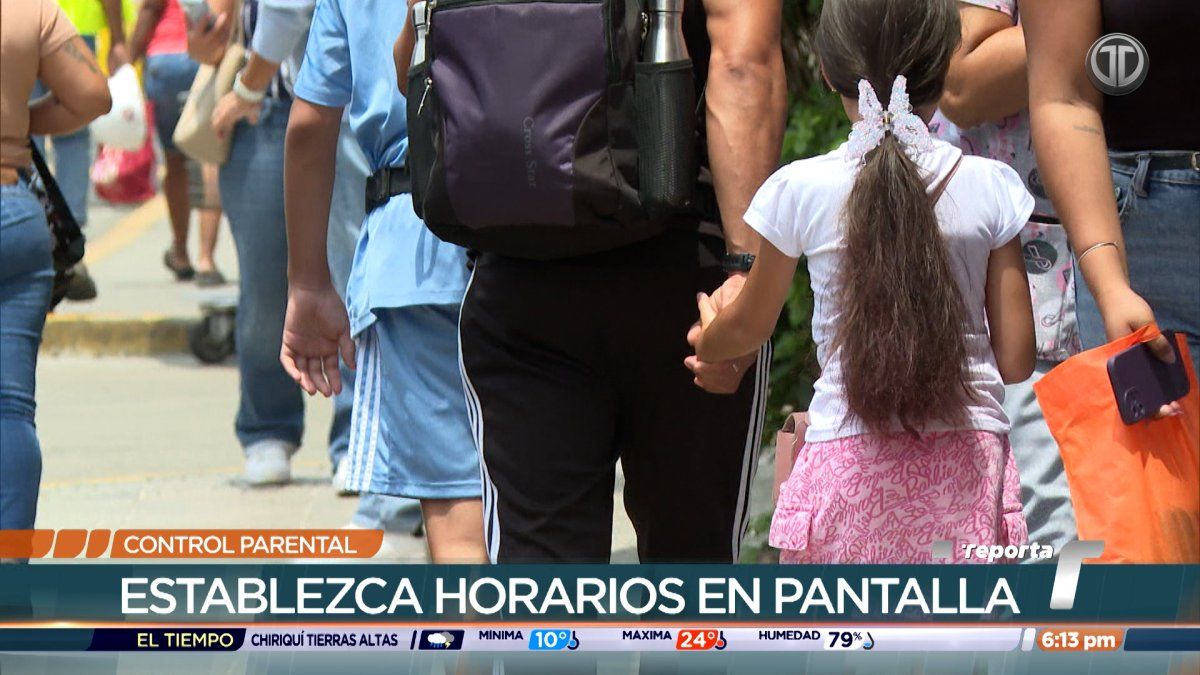 A parent configuring parental controls on a child's tablet while the child uses the device
