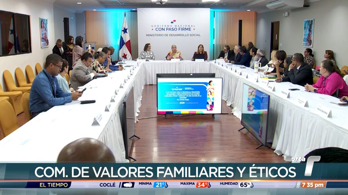 Members of the national commission seated around a conference table during a meeting to discuss family and civic values