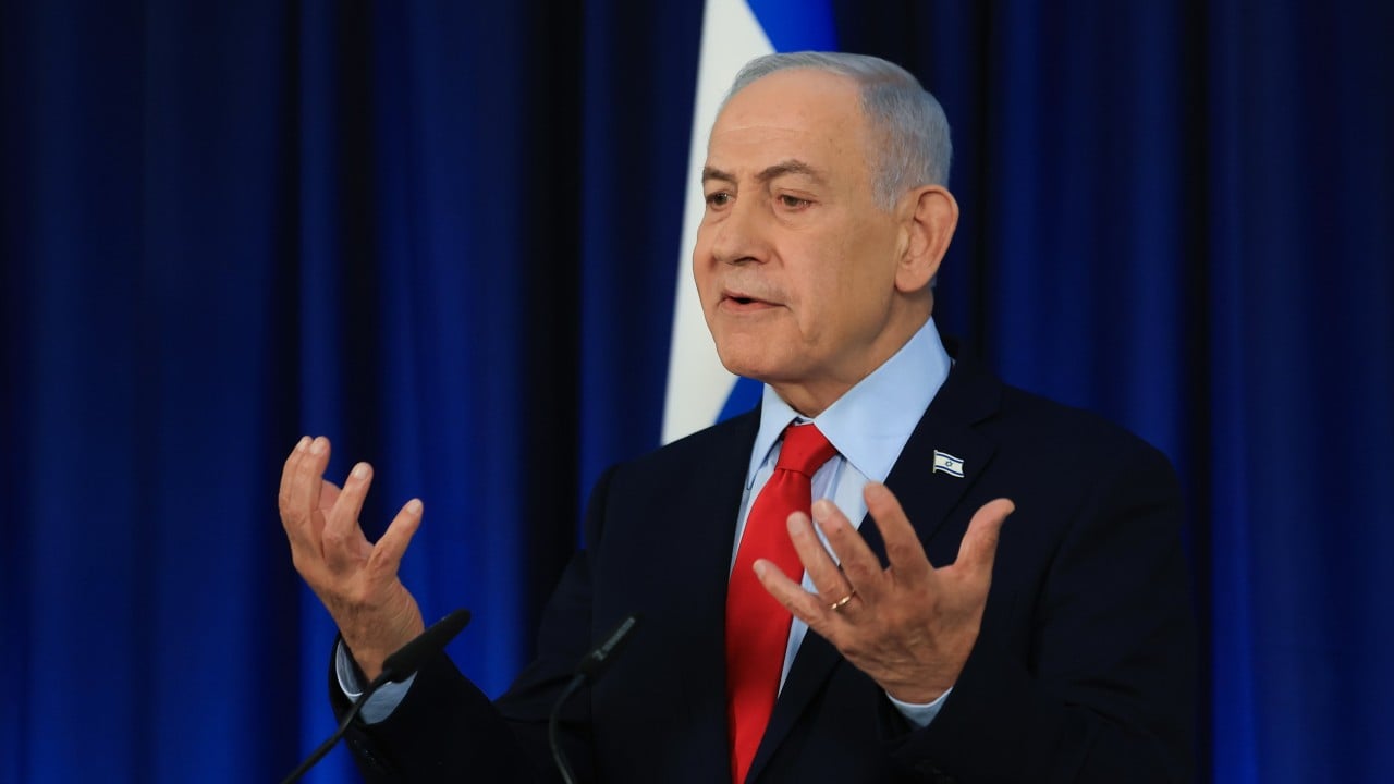 Israeli Prime Minister Benjamin Netanyahu speaking at a podium during a public address