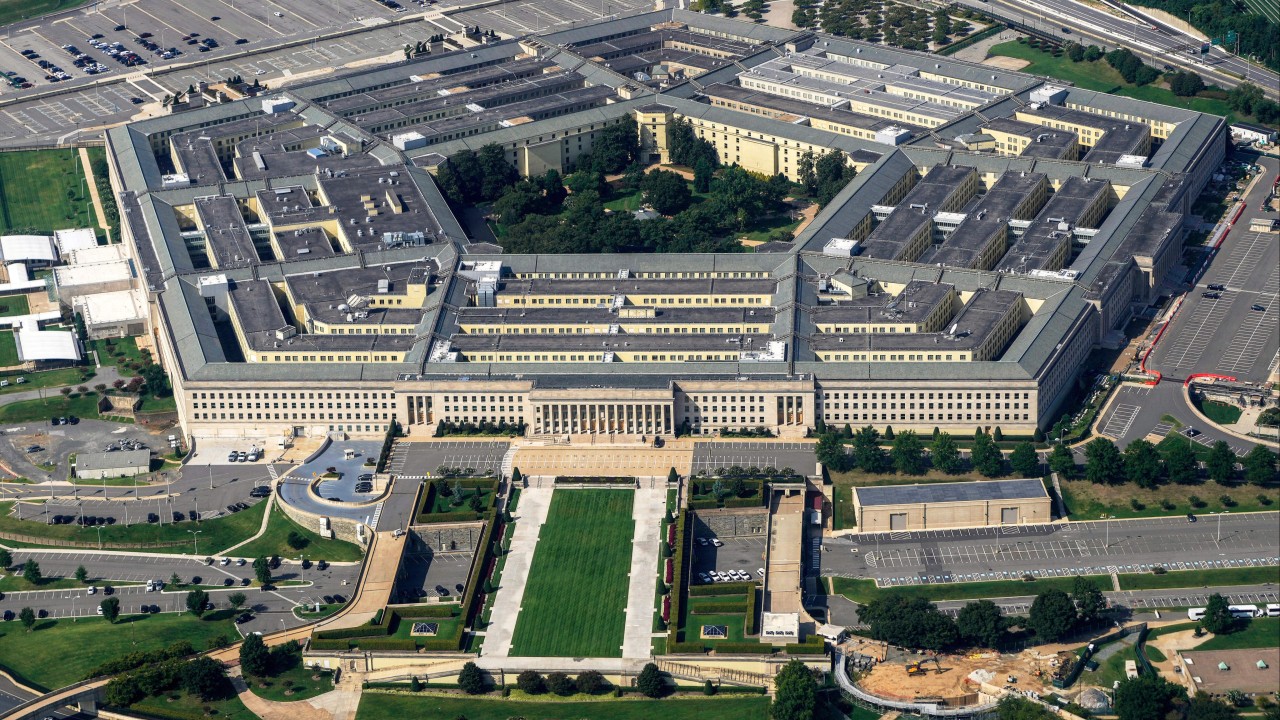 Reporters gathered outside the Pentagon building, some wearing press credentials and carrying cameras