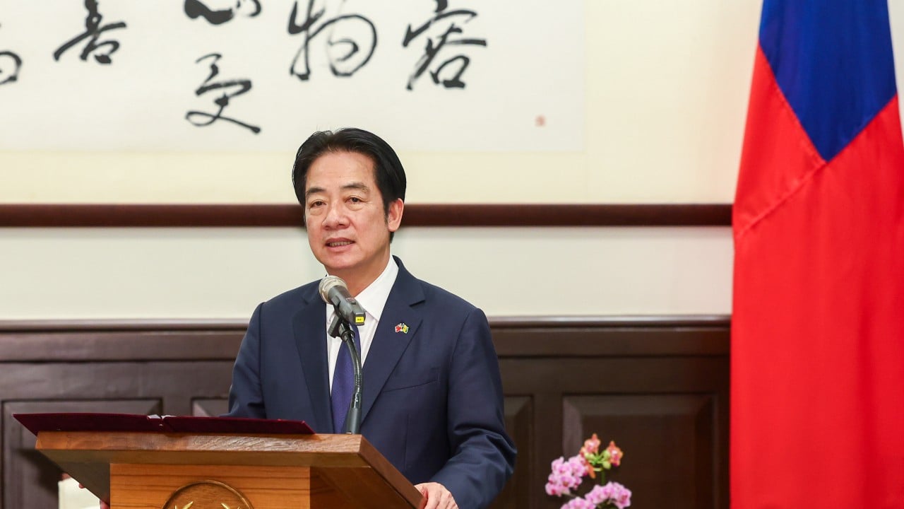 Taiwanese leader William Lai speaking at a podium during a public event, with attendees and cameras in the background