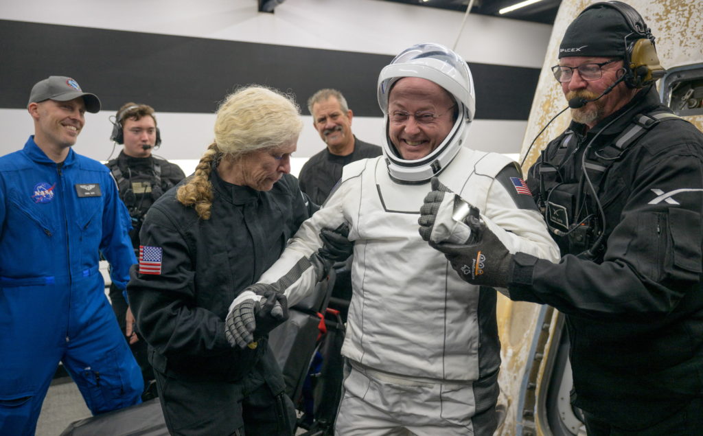 NASA astronaut in a spacesuit orbiting above Earth, representing the International Space Station medical mystery.