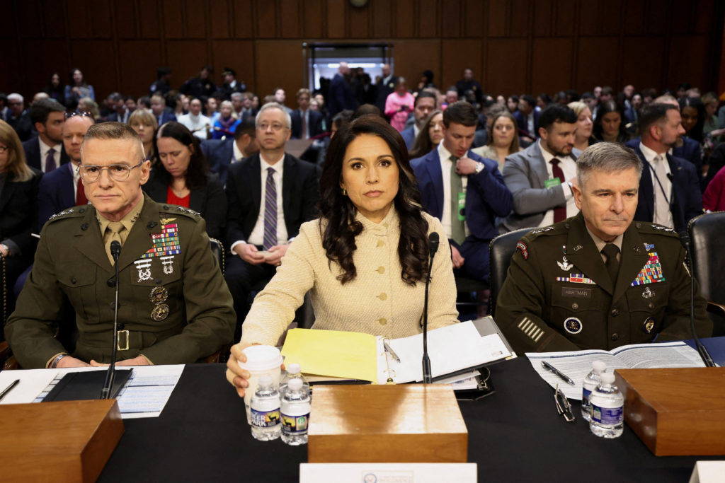 Lawmakers and witnesses including Gabbard, Patel and Ratcliffe testifying before a House committee in a congressional hearing room