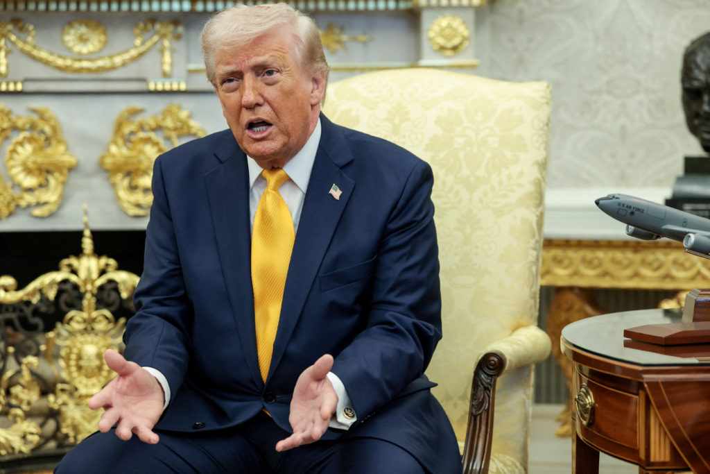 Donald Trump seated next to Japanese Prime Minister Sanae Takaichi during a joint appearance, speaking to reporters