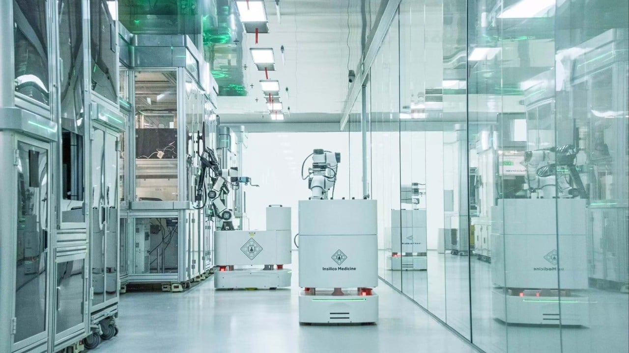 Researchers reviewing AI-generated drug discovery data on a computer screen in a pharmaceutical lab