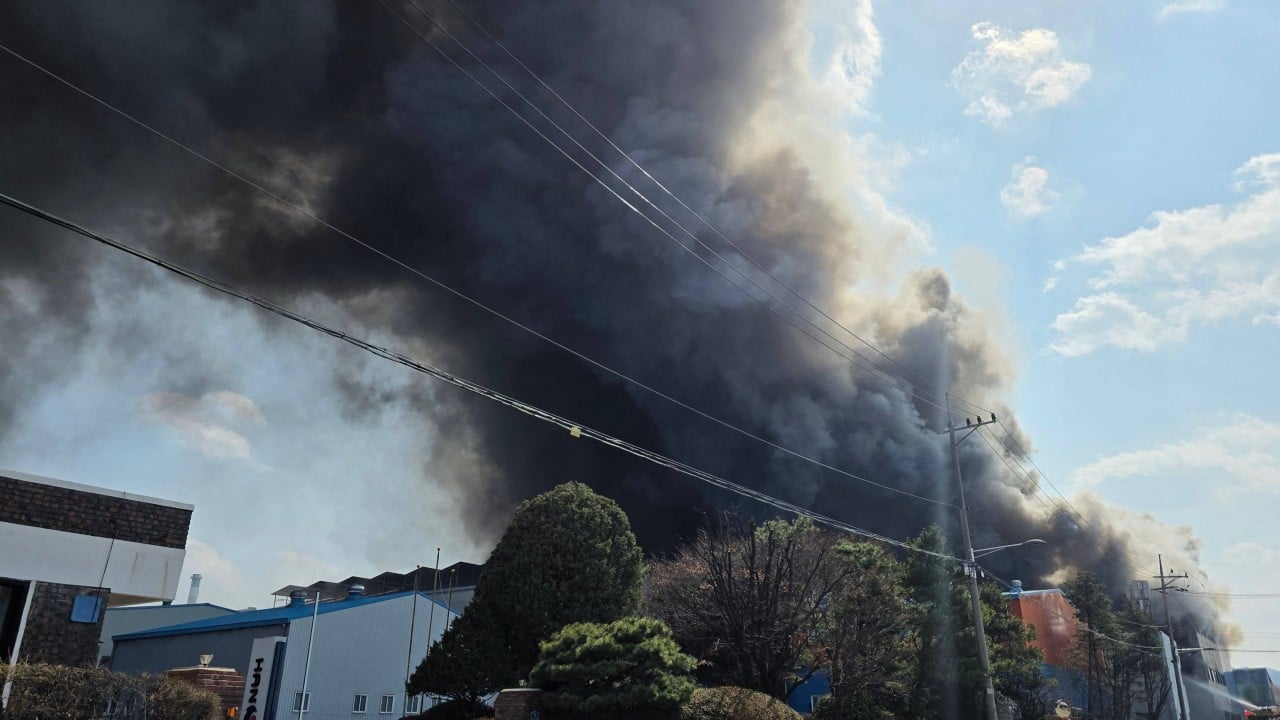 Emergency responders and smoke at a burning car-parts factory in Daejeon, South Korea