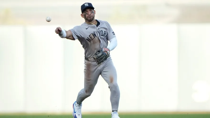 José 'Chema' Caballero celebrating a run for the Yankees and Edmundo Sosa in a Phillies uniform, representing Panama on MLB Opening Day