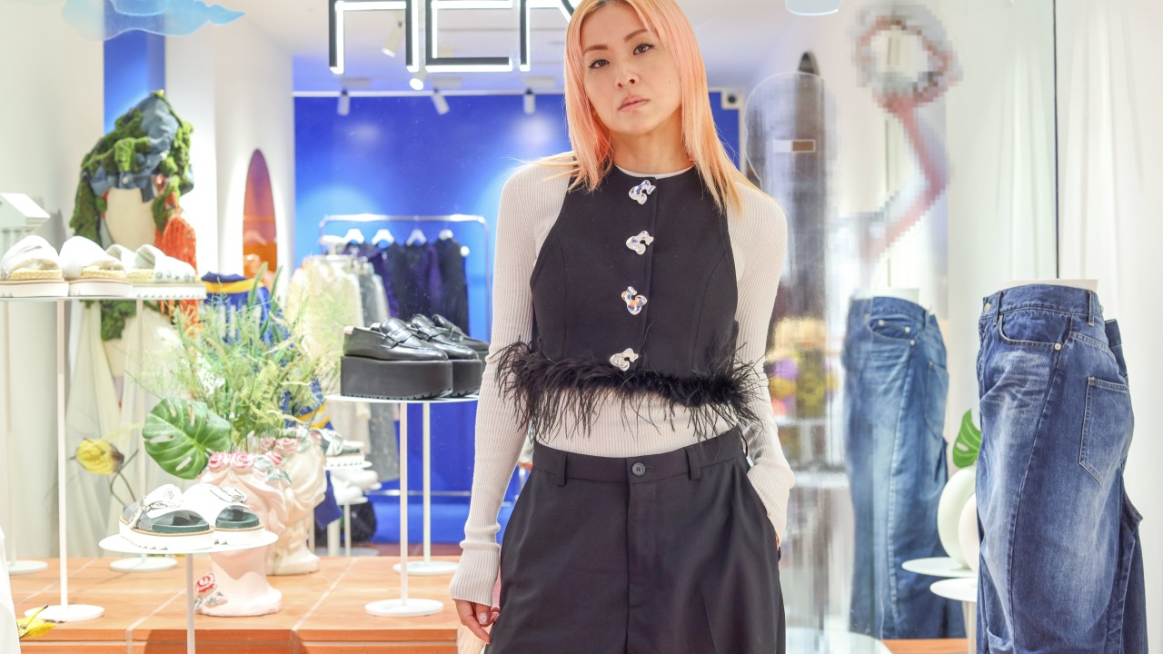 Hilary Tsui posing stylishly outside her Her boutique in Causeway Bay, wearing a fashionable outfit