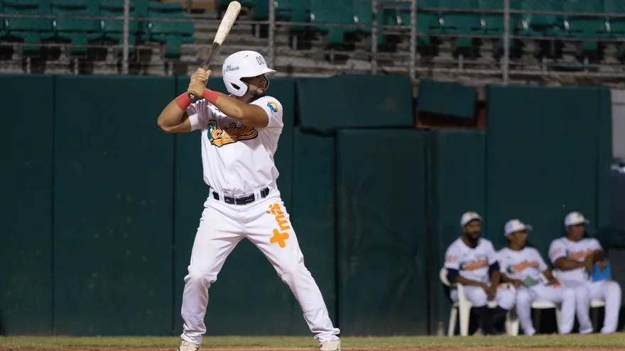 Players from Panama Metro and Colón teams on the baseball field with fans and stadium lighting in the background