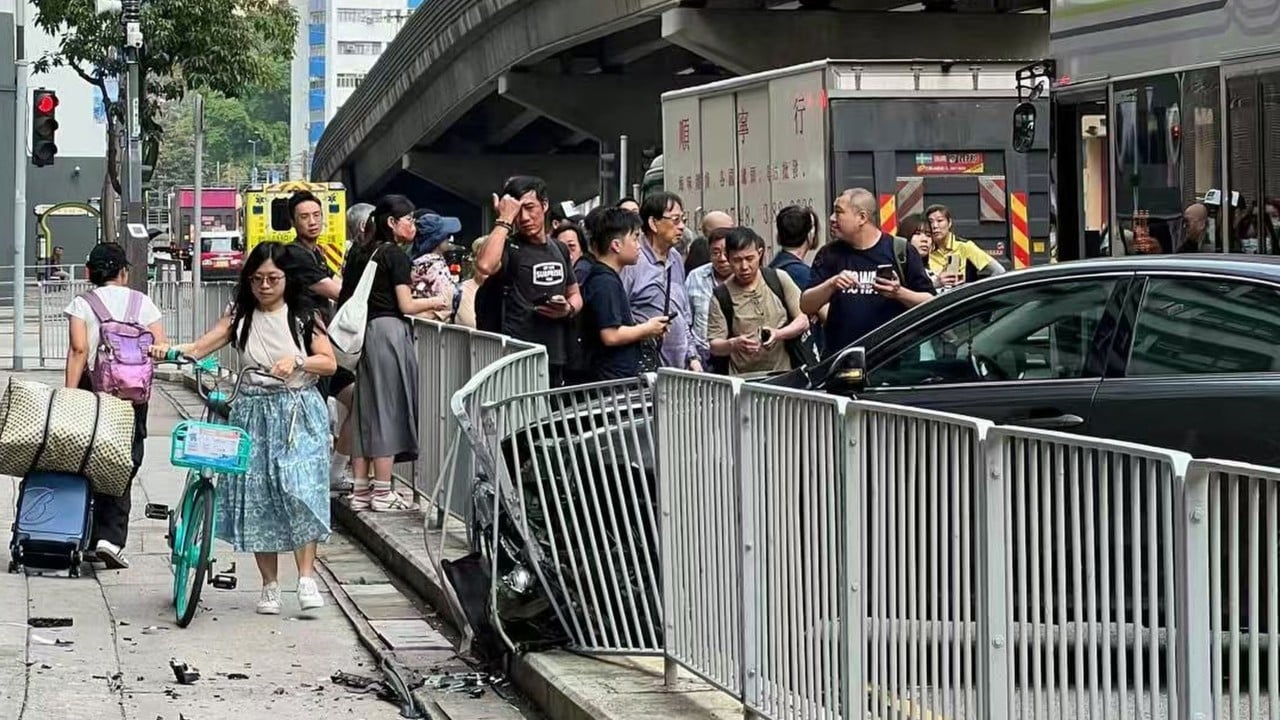 Police activity near a roadside barrier and damaged vehicles along Pui To Road in Tuen Mun, Hong Kong