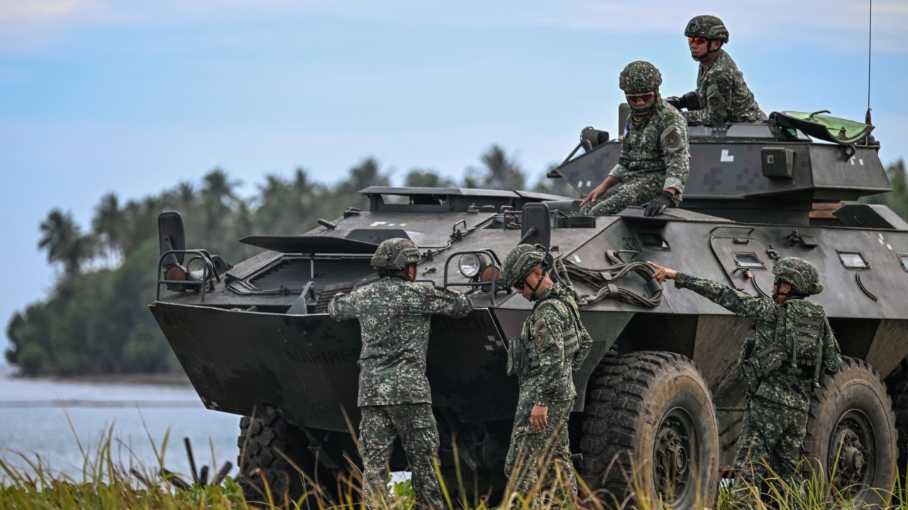 A Philippine military vessel and troops in a coastal setting, suggesting territorial defense readiness
