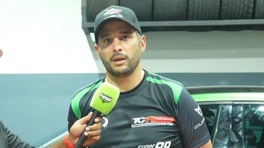 Mario Bárcenas on the podium at a TCR Panama event with team members and his touring car in the background