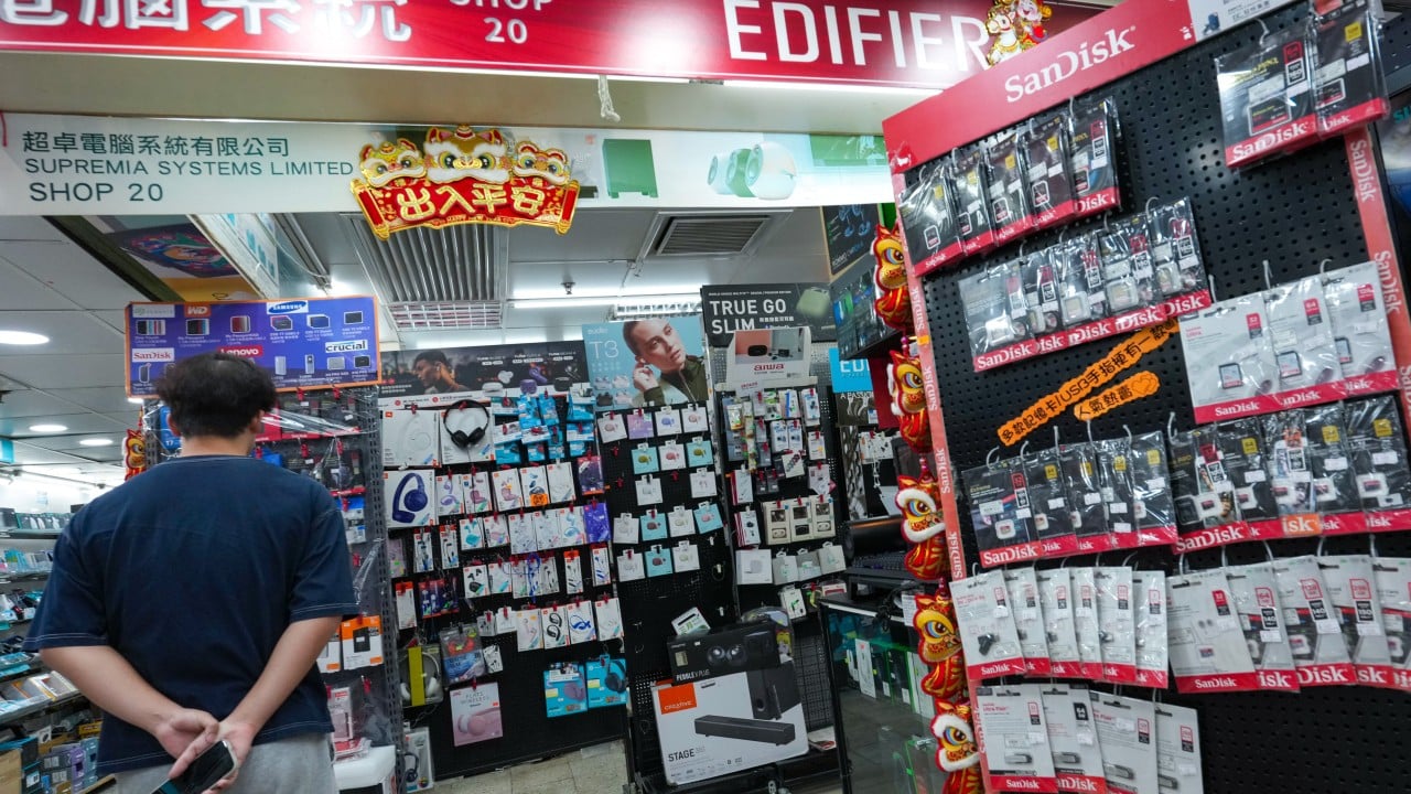 A Hong Kong photographer handling SD cards and an external hard drive used to back up large image files.