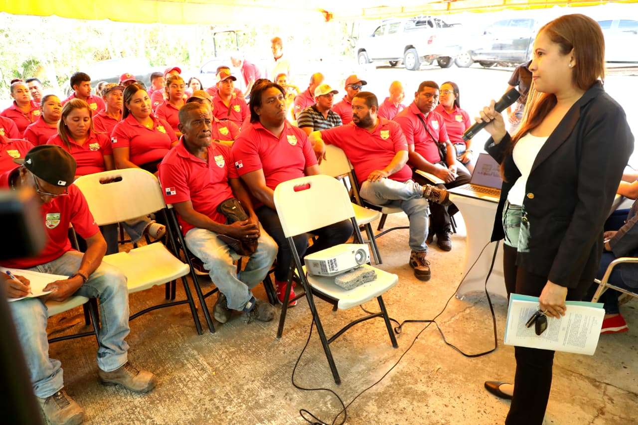 Municipal human resources staff leading a training session for community board members in a municipal meeting room with participants seated