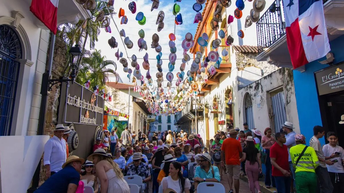 Visitors walking through Casco Antiguo in Panama City near historic buildings and outdoor dining areas during a community event