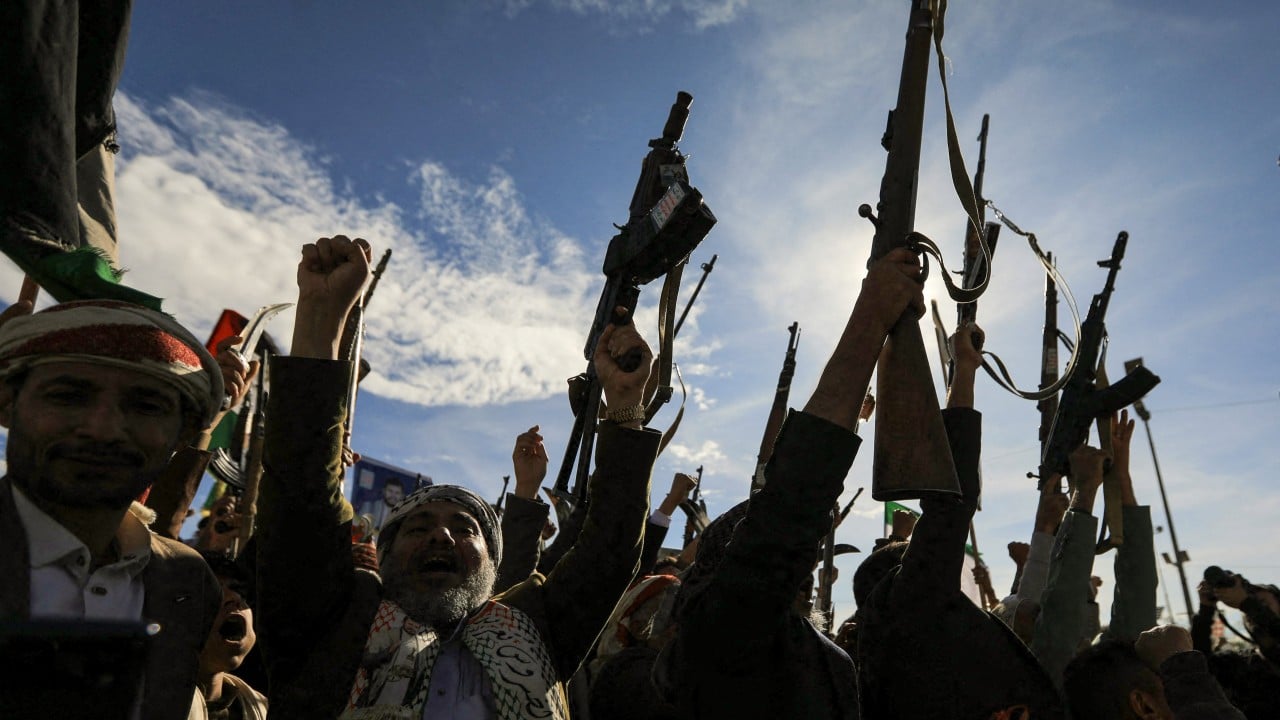 A cargo ship passing near a strategic strait as missile and interception imagery suggests rising regional tensions