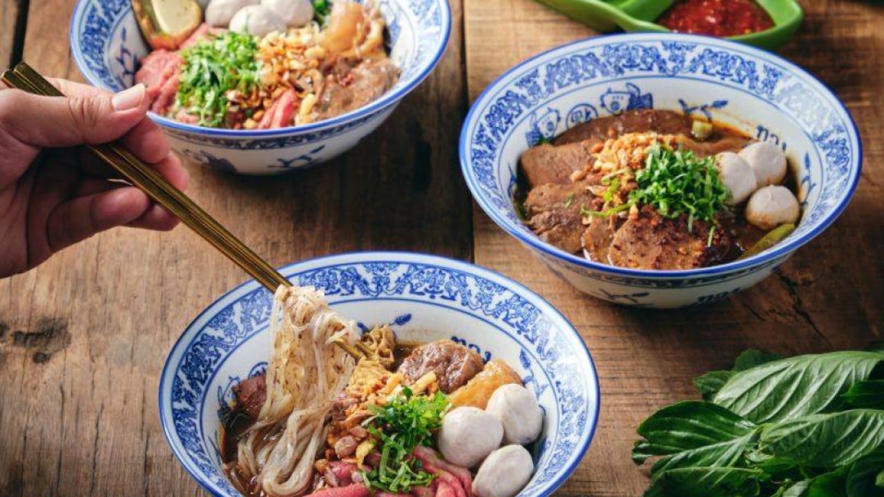 Bowls of Thai boat noodles topped with sliced beef and pork, representing ThongSmith's slow-simmered broth and premium toppings