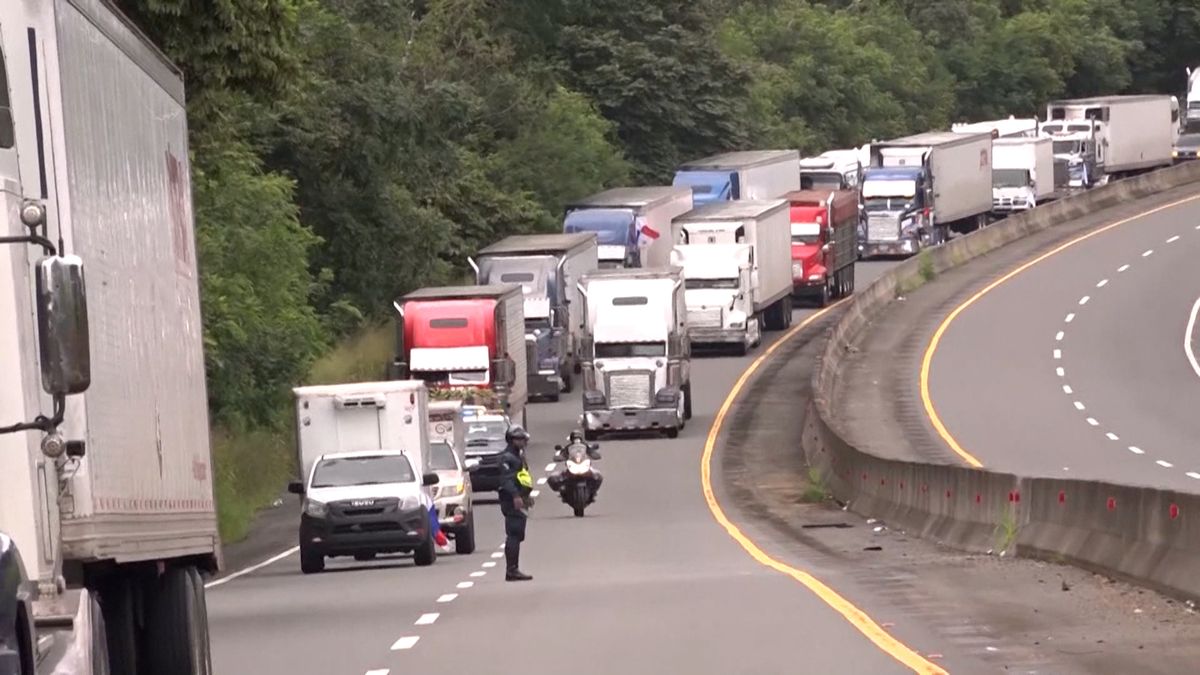 Heavy trucks on a Panamanian highway during a holiday traffic restriction period
