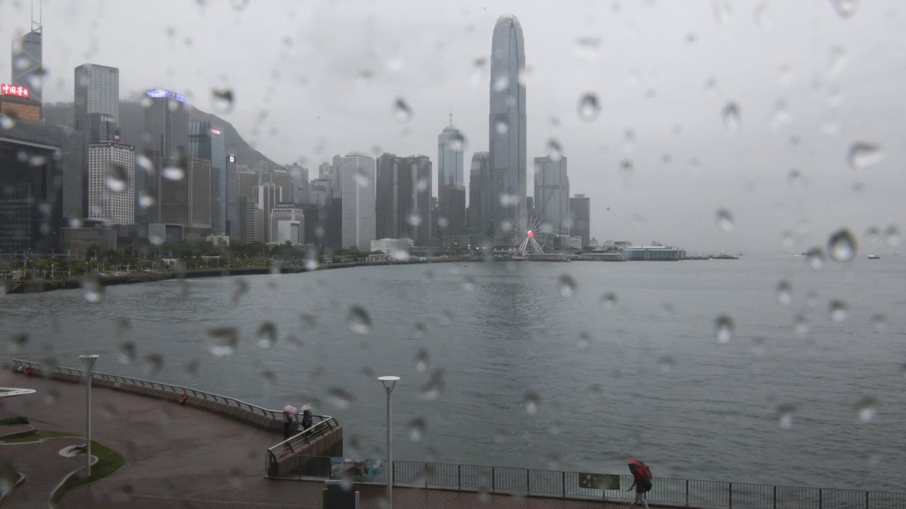 Hong Kong skyline and harbour under heavy cloud cover signaling stormy weather
