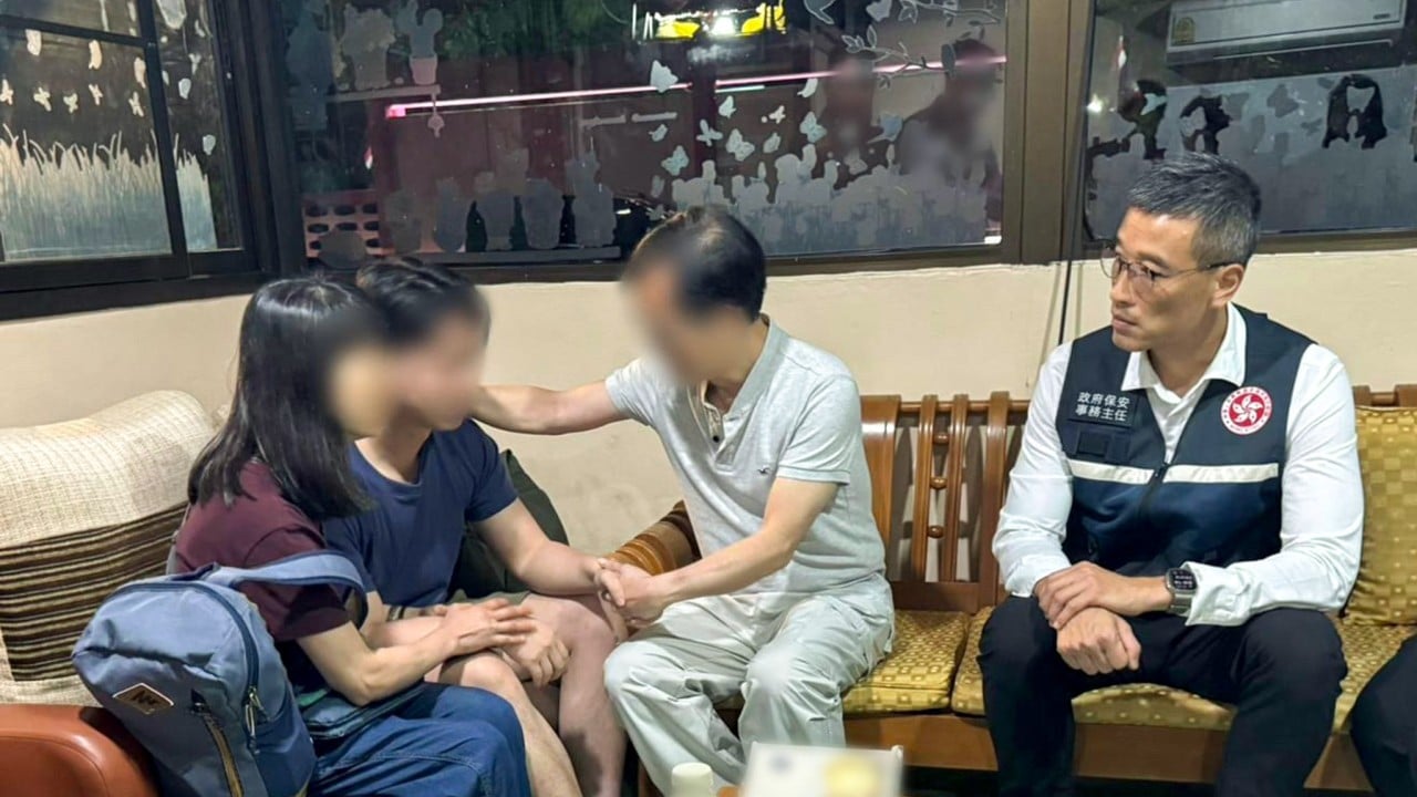 A rescue operation scene at a border or transport facility showing authorities assisting a distressed person and coordinating with officials