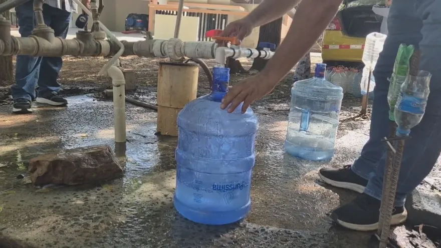 Close-up of a household tap with running water in a residential area of Llano de Piedra