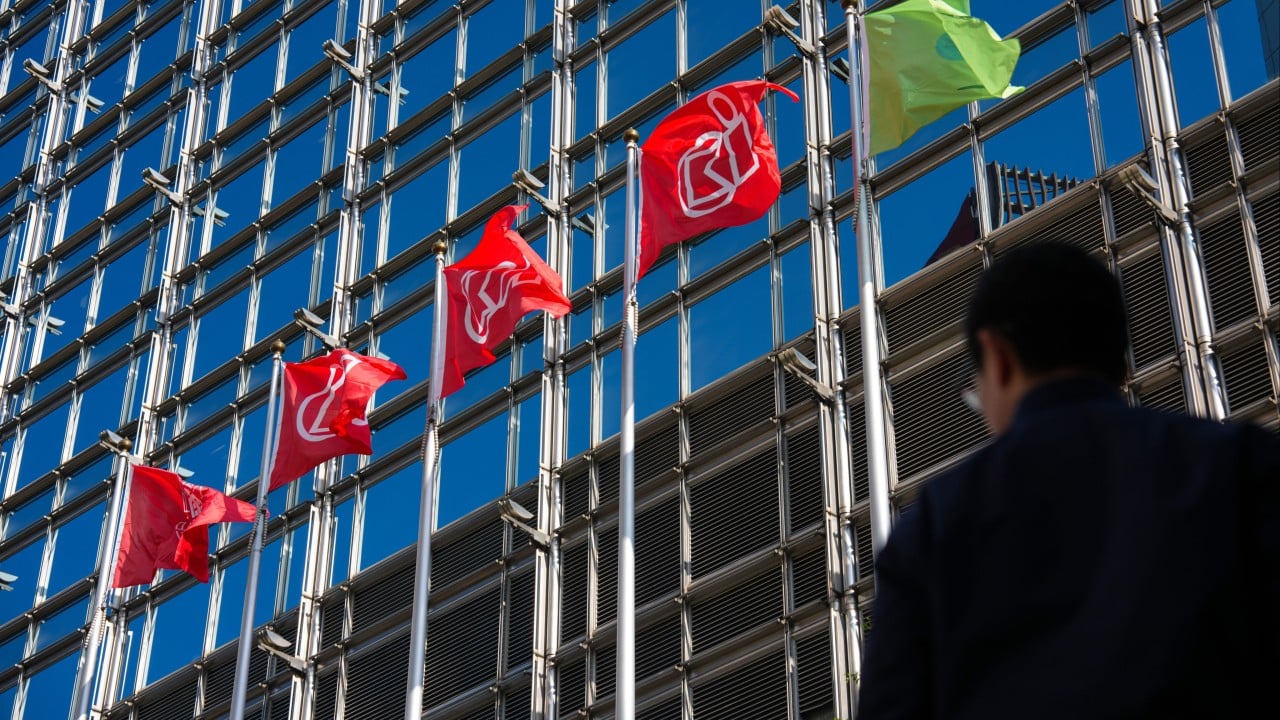 Container cranes and container stacks at a busy port, representing CK Hutchison's ports business
