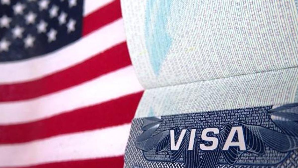 Panamanian travelers near the entrance of the U.S. Embassy in Panama City preparing documents for visa appointments