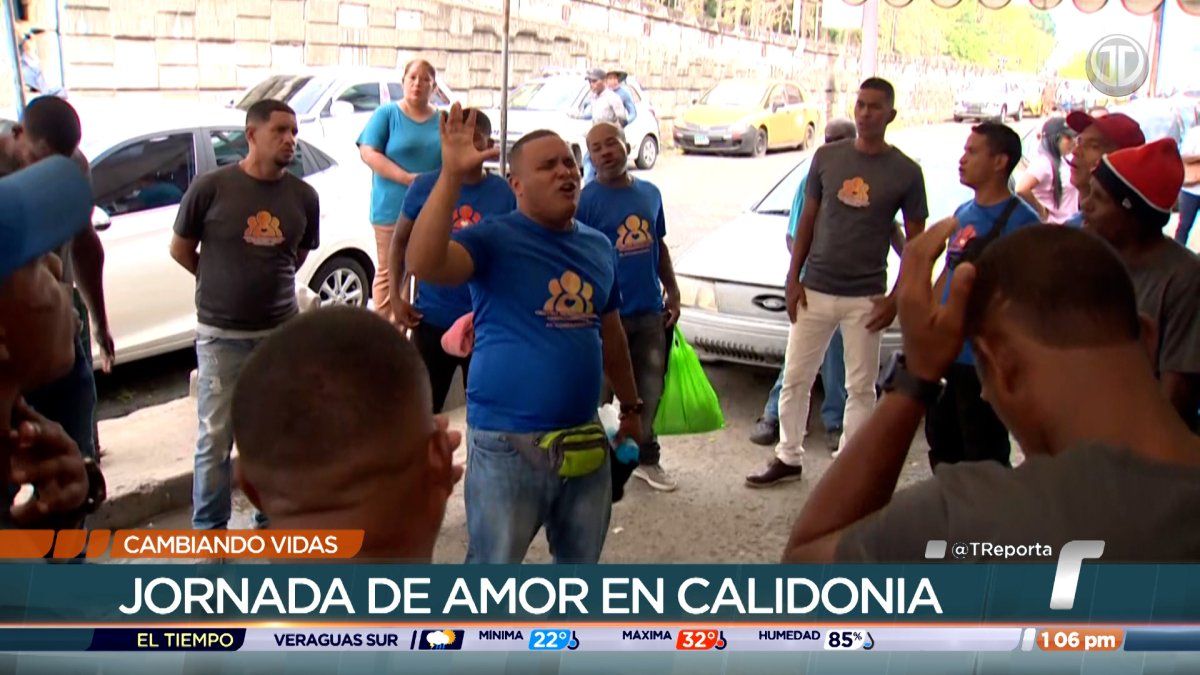 Volunteers handing out food packages to homeless people in a street area of Calidonia, Panama City