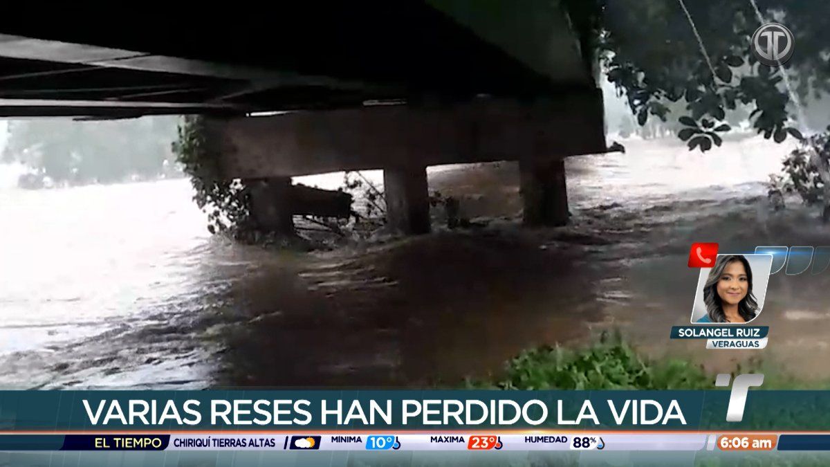 Flooded river in rural Veraguas with muddy water blocking access near homes and farmland