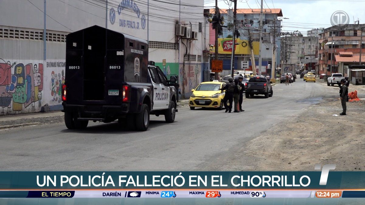 Police officers standing in an urban neighborhood during an investigation after a shooting in El Chorrillo