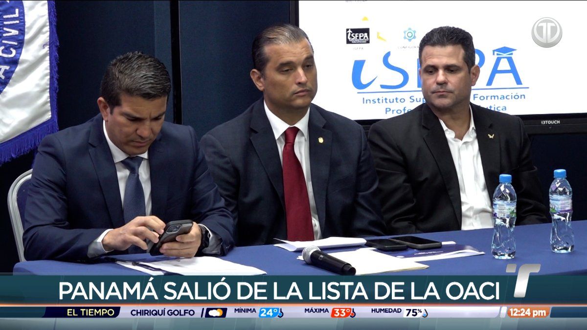 An airplane taxiing at an airport in Panama with control tower in the background