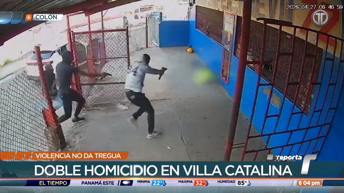 Police officers investigate a crime scene in a residential area of Puerto Pilón, Colón, after a double homicide