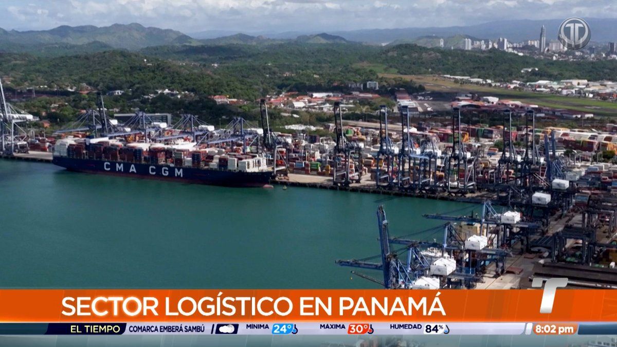 Cargo containers stacked at a Panamanian port with cranes and shipping equipment in the background