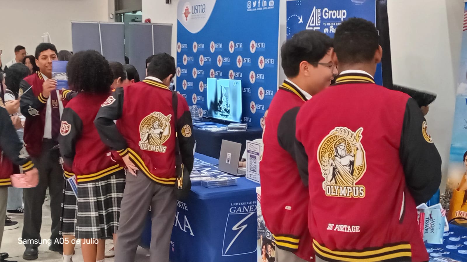Students visiting booths and receiving career guidance at a vocational fair in Panama City