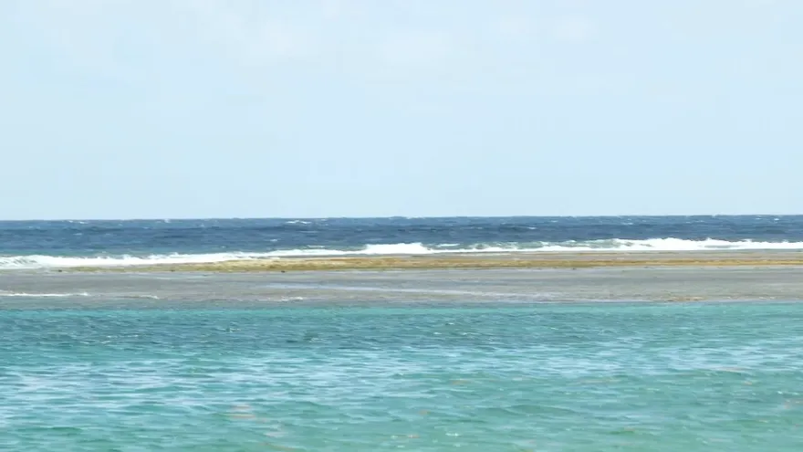 Waves hitting the Pacific shoreline in Panama under cloudy weather conditions