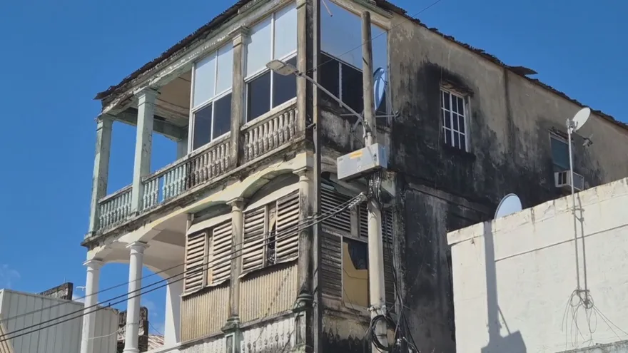 Buildings in downtown Colón, Panama, with crews preparing to clean and paint facades in the historic urban center