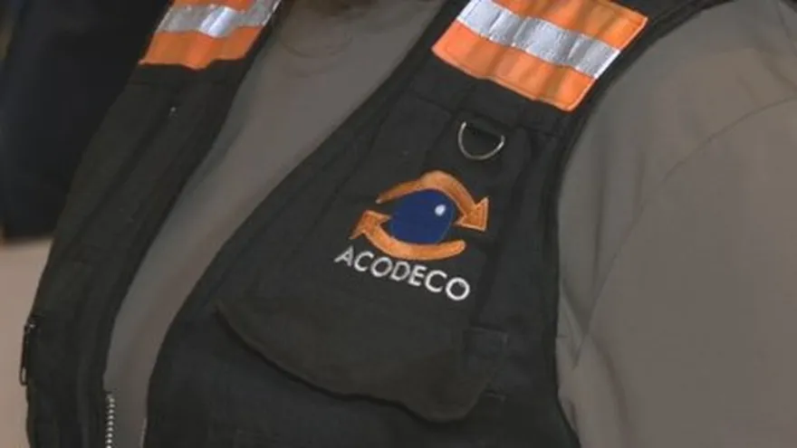 A consumer inspecting price labels on products inside a retail store in Panama