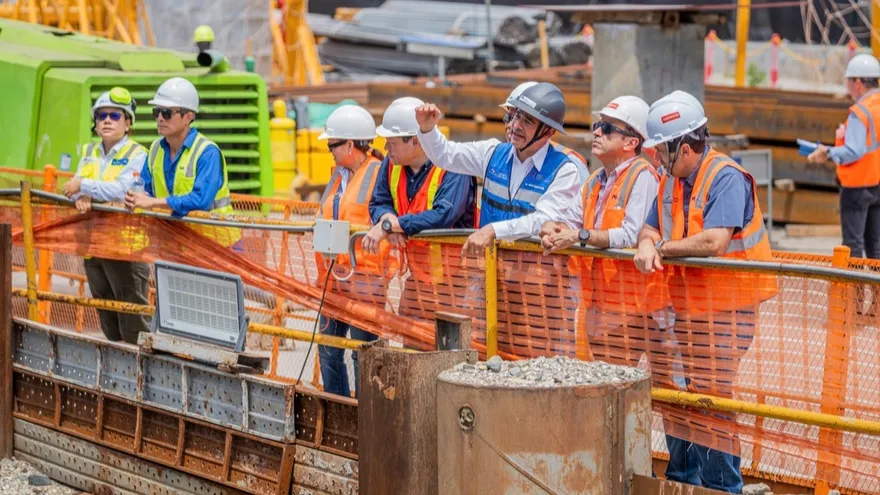 Construction workers and officials inspecting the Fourth Bridge over the Panama Canal site during a progress tour