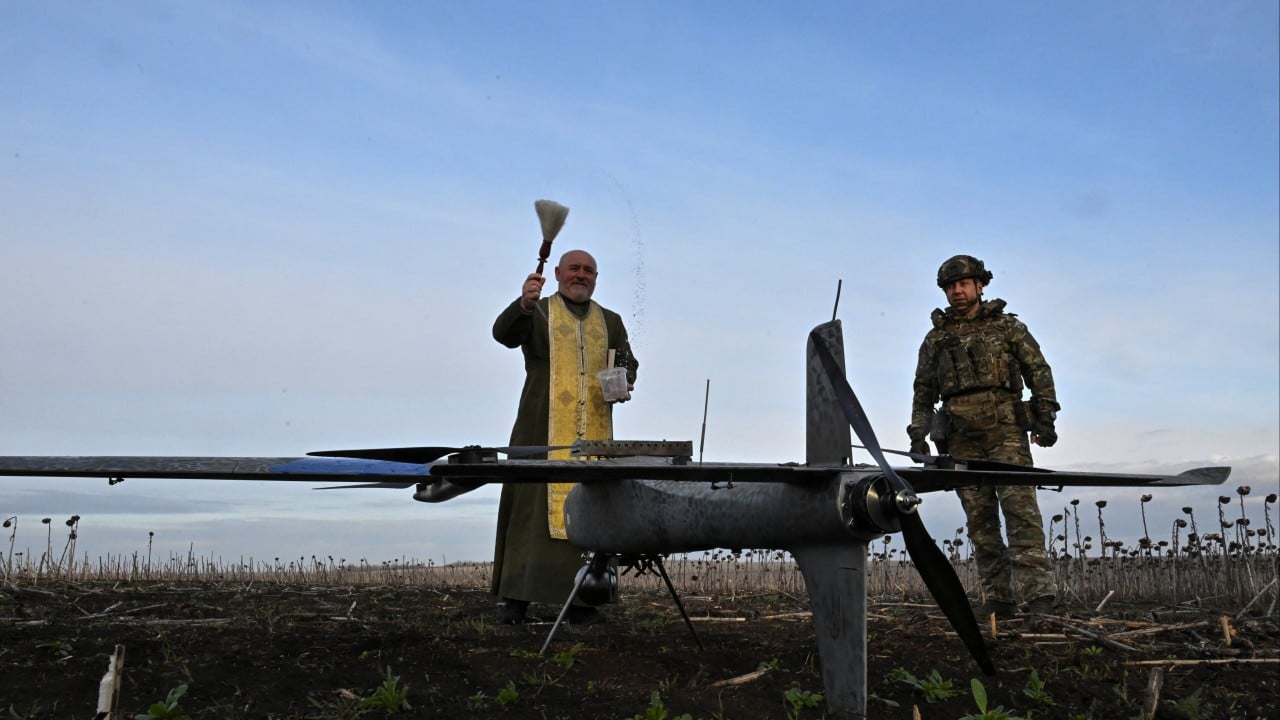 Ukrainian civilians and soldiers near a damaged street during the war, with Orthodox Easter symbols in the foreground