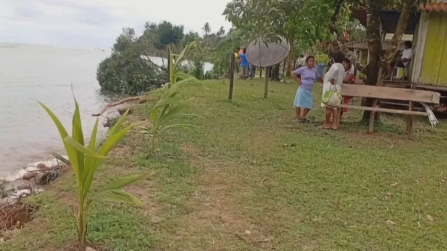 Homes near the Río Veraguas with water damage and muddy flood conditions after the river swelled