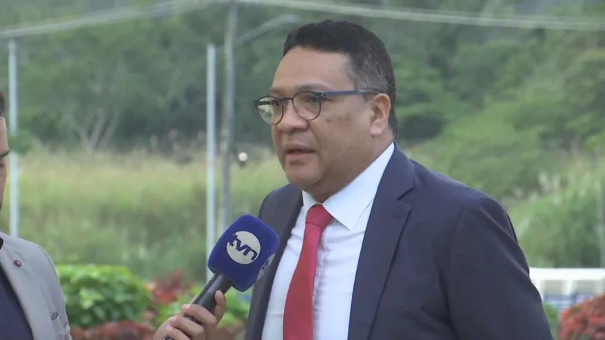 A Panamanian official speaking at a podium during a public statement about a travel controversy
