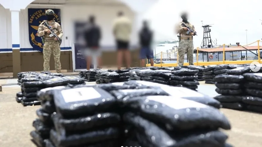 Security personnel inspecting a confiscated boat after a large drug seizure at sea off Panama's Pacific coast