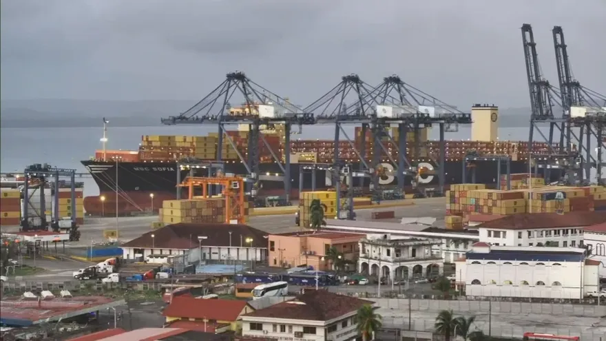 Cargo operations and container activity at a Panama port terminal with cranes and dock workers