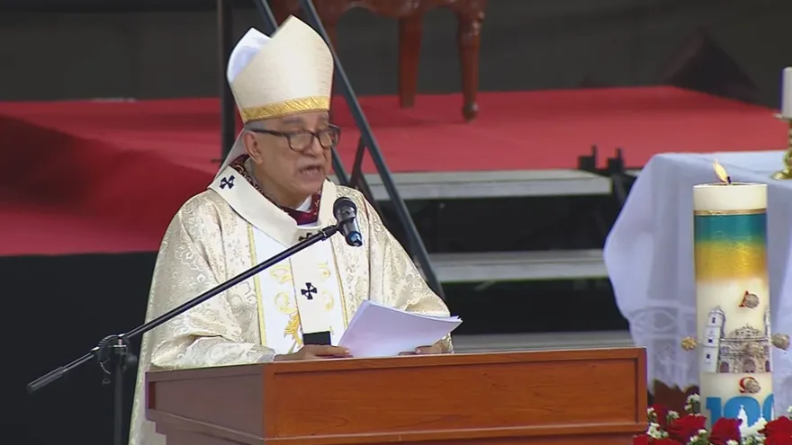 Archbishop of Panama speaking at a religious ceremony as attendees listen inside a cathedral