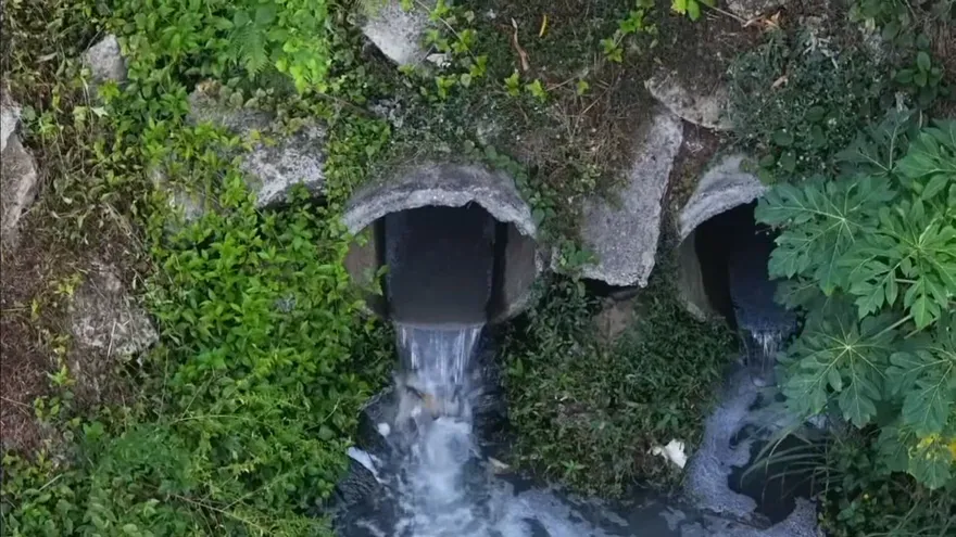 Residents in a Panama neighborhood near standing wastewater and sewage-affected streets