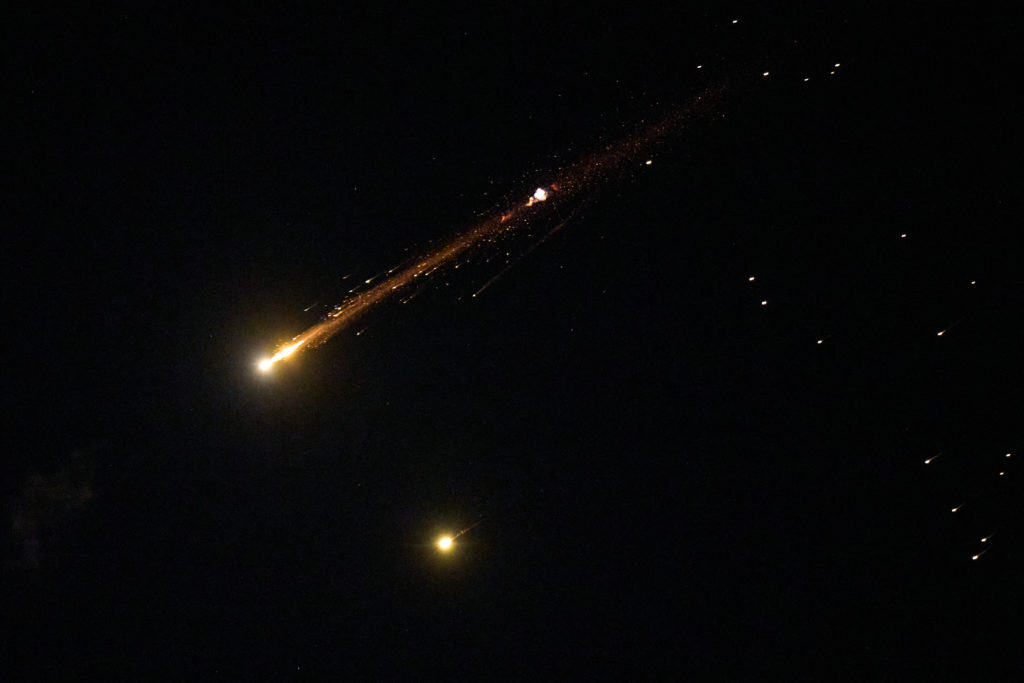 A cybersecurity analyst monitoring digital threats on multiple screens as critical infrastructure networks are discussed