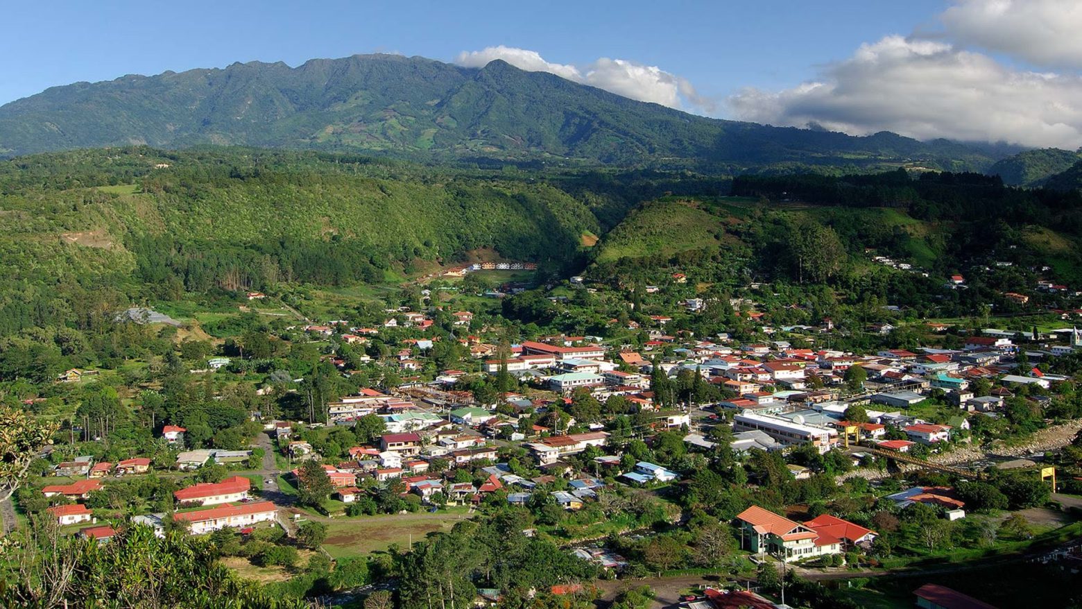 A scenic view of Boquete’s mountain valley with green hills, a town center and the highland landscape of Chiriquí province