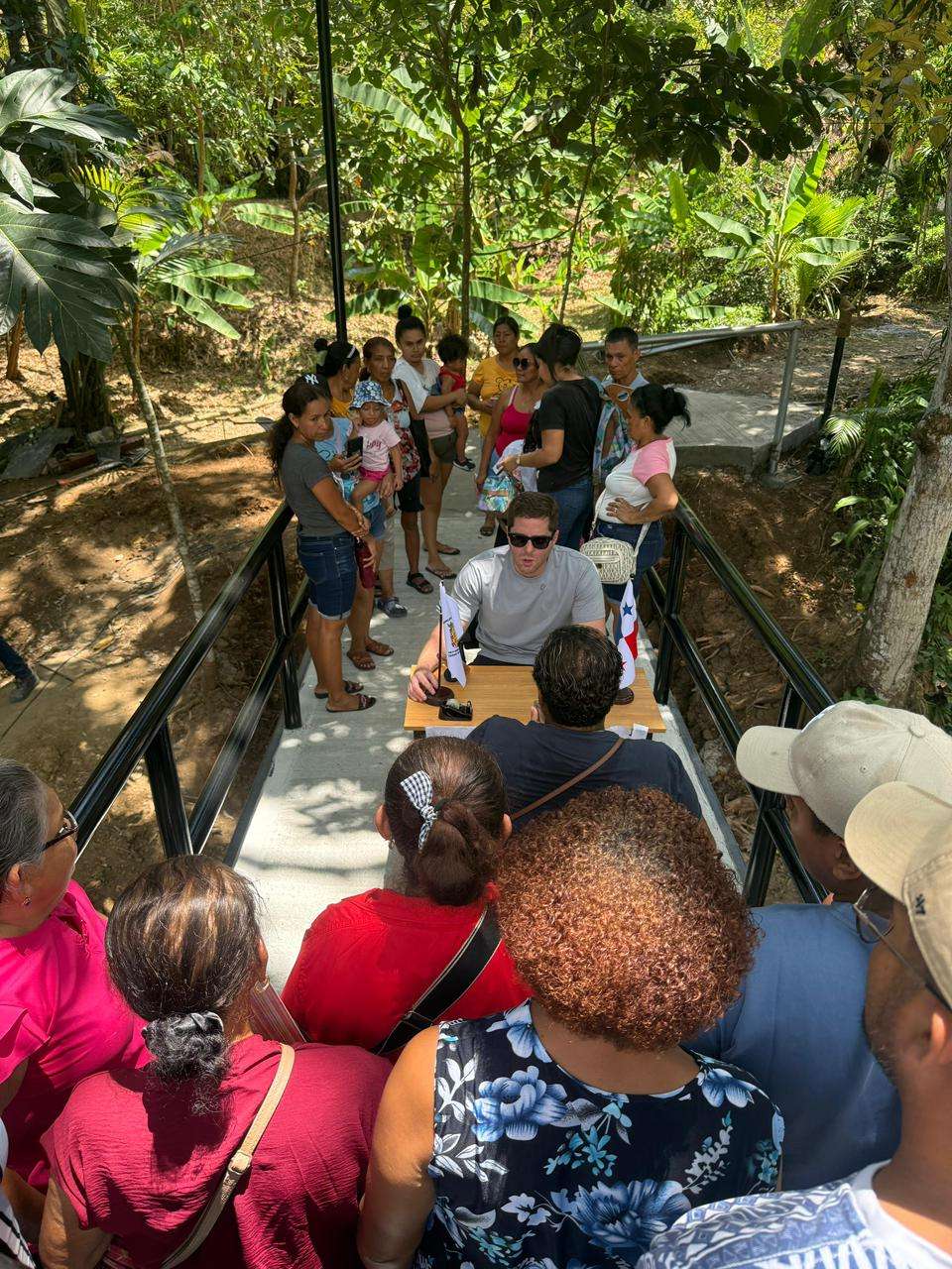 Residents crossing a newly built pedestrian bridge over a creek in El Centenario, Alcalde Díaz, Panama City