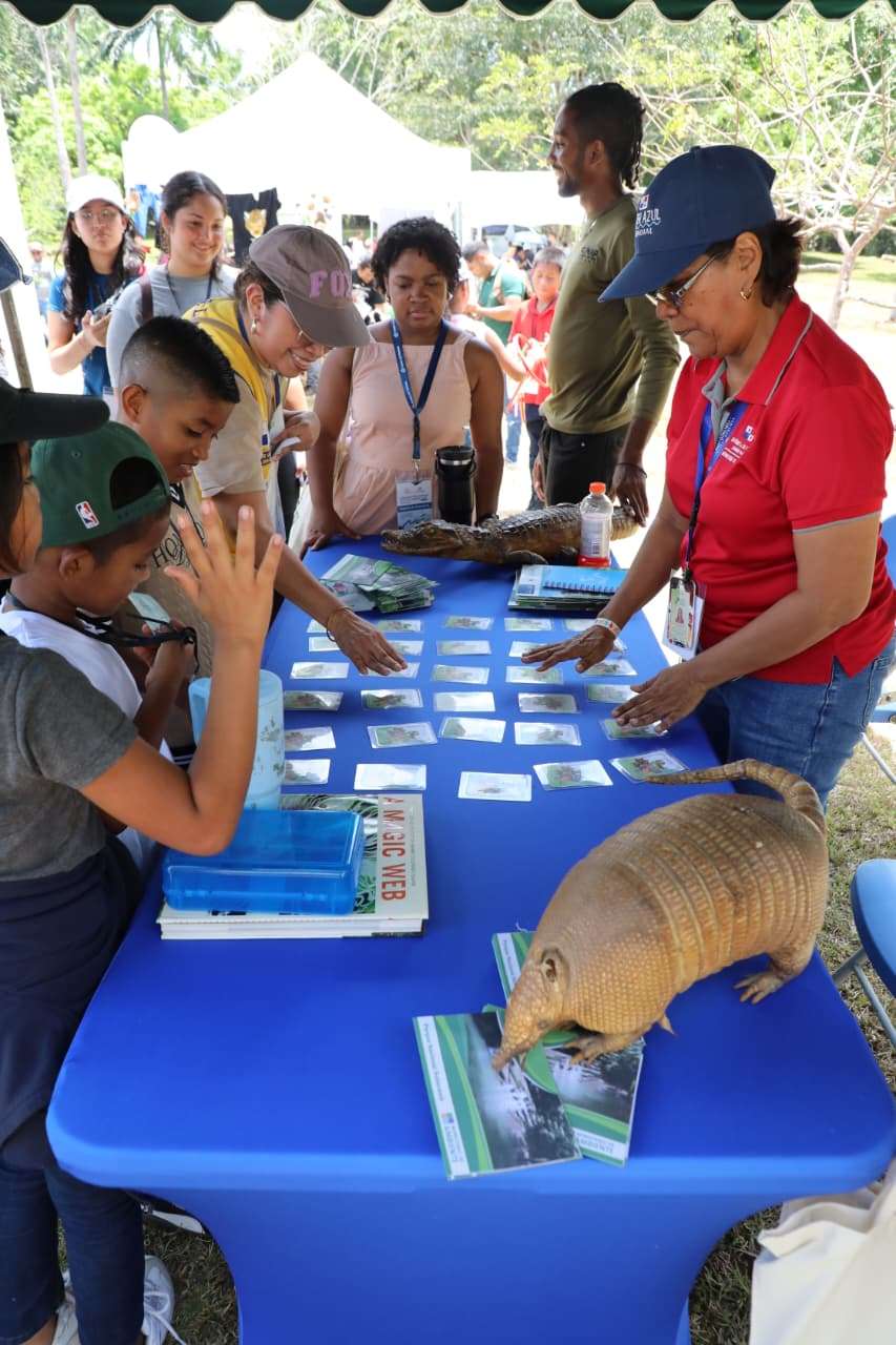 Families and children taking part in harpy eagle festival activities at Summit Botanical Garden in Panama City
