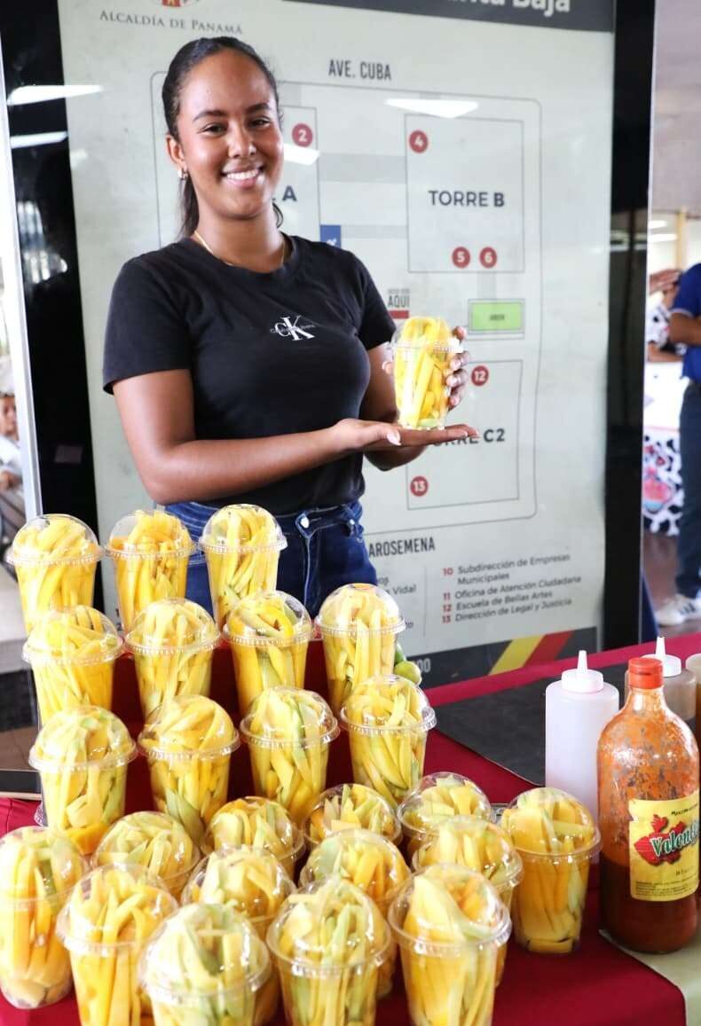 Shoppers browsing stalls with fresh vegetables, fruits, crafts and other local products at a municipal market in Panama City